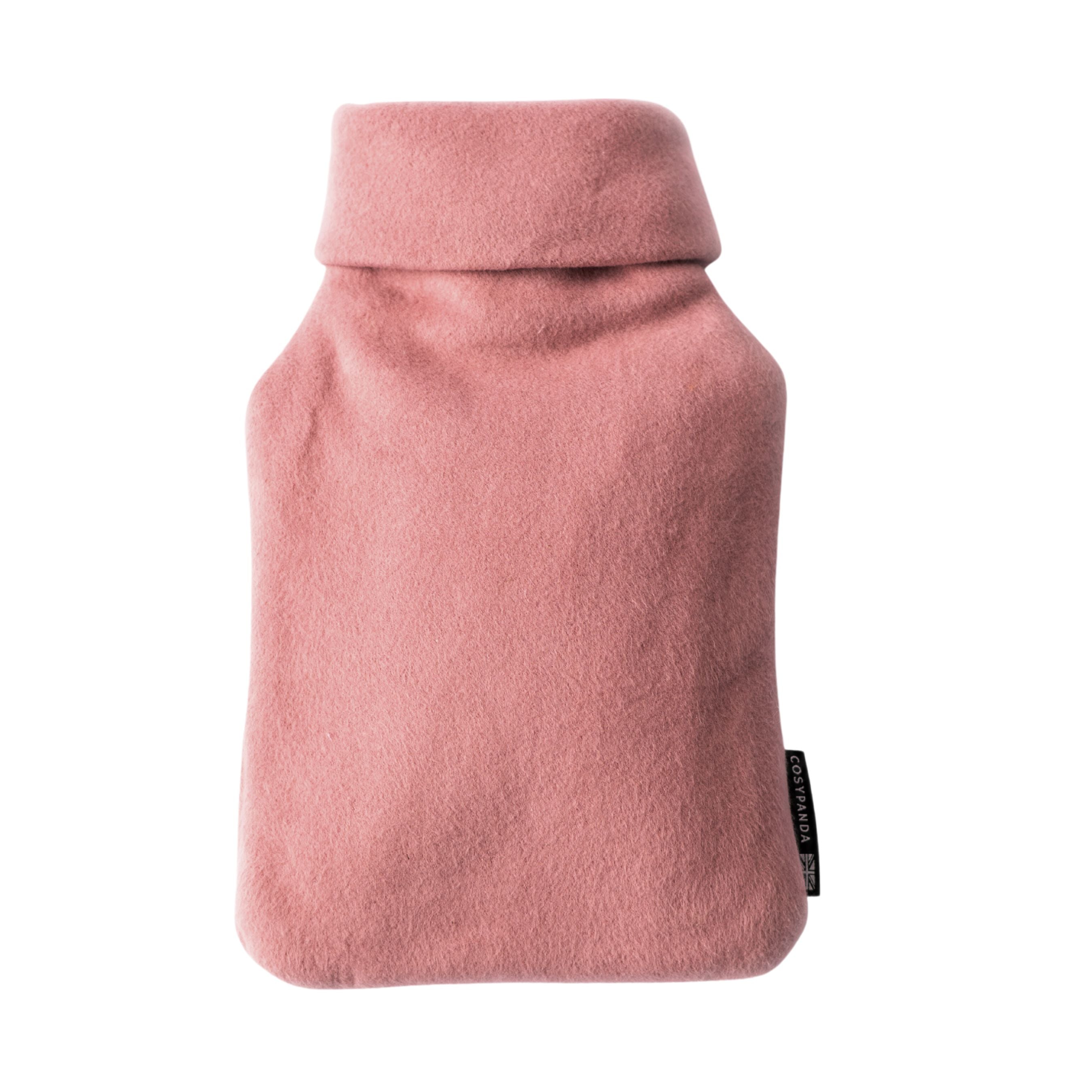 A cozy pink organic cotton hot water bottle with a roll-neck design, handmade in the UK, perfect for warmth and comfort.