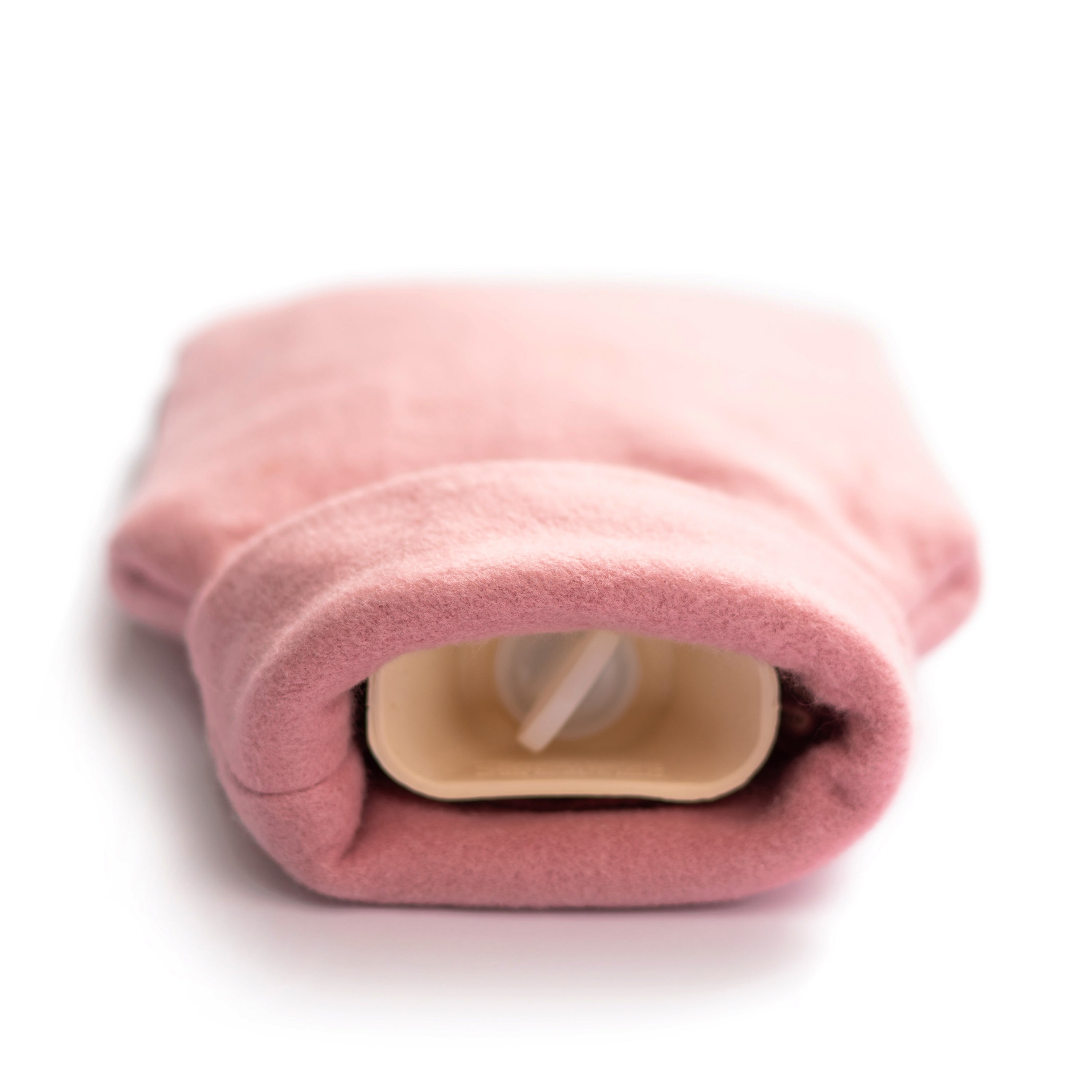 A cozy pink organic cotton hot water bottle with a roll-neck design, handmade in the UK, perfect for warmth and comfort.