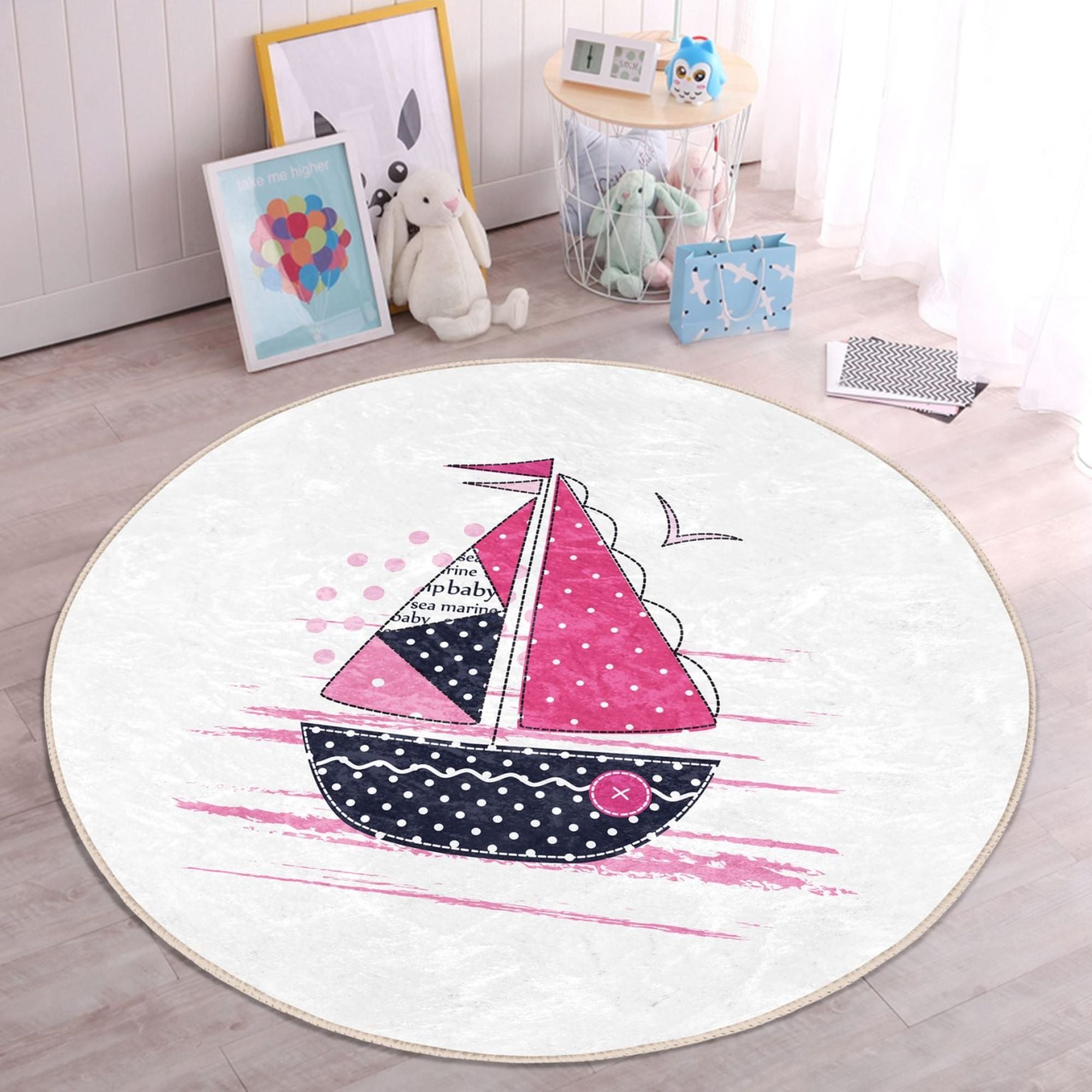 A colorful pink sailboat pattern rug designed for kids' rooms, showcasing vibrant colors and a soft texture, perfect for play areas.