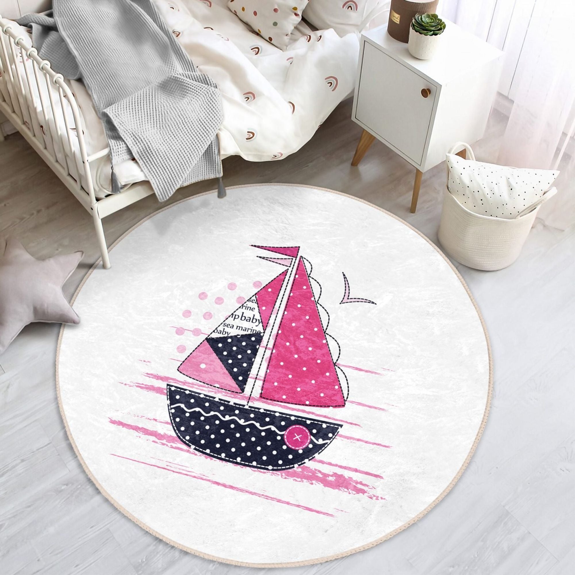A colorful pink sailboat pattern rug designed for kids' rooms, showcasing vibrant colors and a soft texture, perfect for play areas.