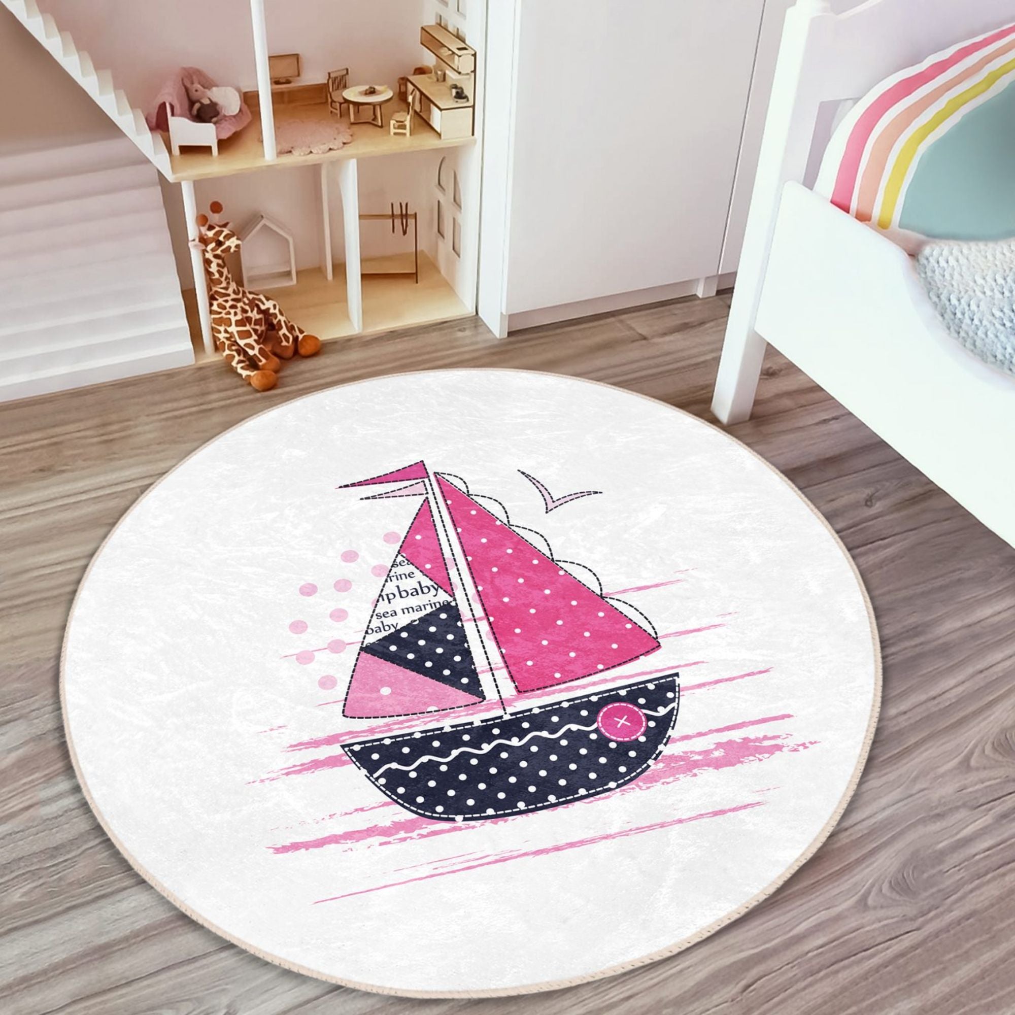 A colorful pink sailboat pattern rug designed for kids' rooms, showcasing vibrant colors and a soft texture, perfect for play areas.