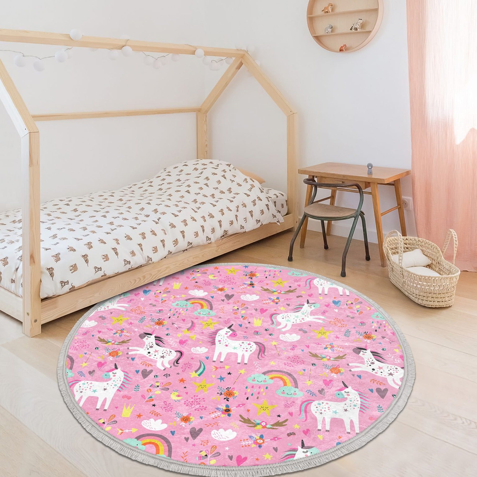 A vibrant pink round rug featuring a whimsical unicorn print, perfect for girls' rooms, made from soft velvet fabric with a non-slip backing.