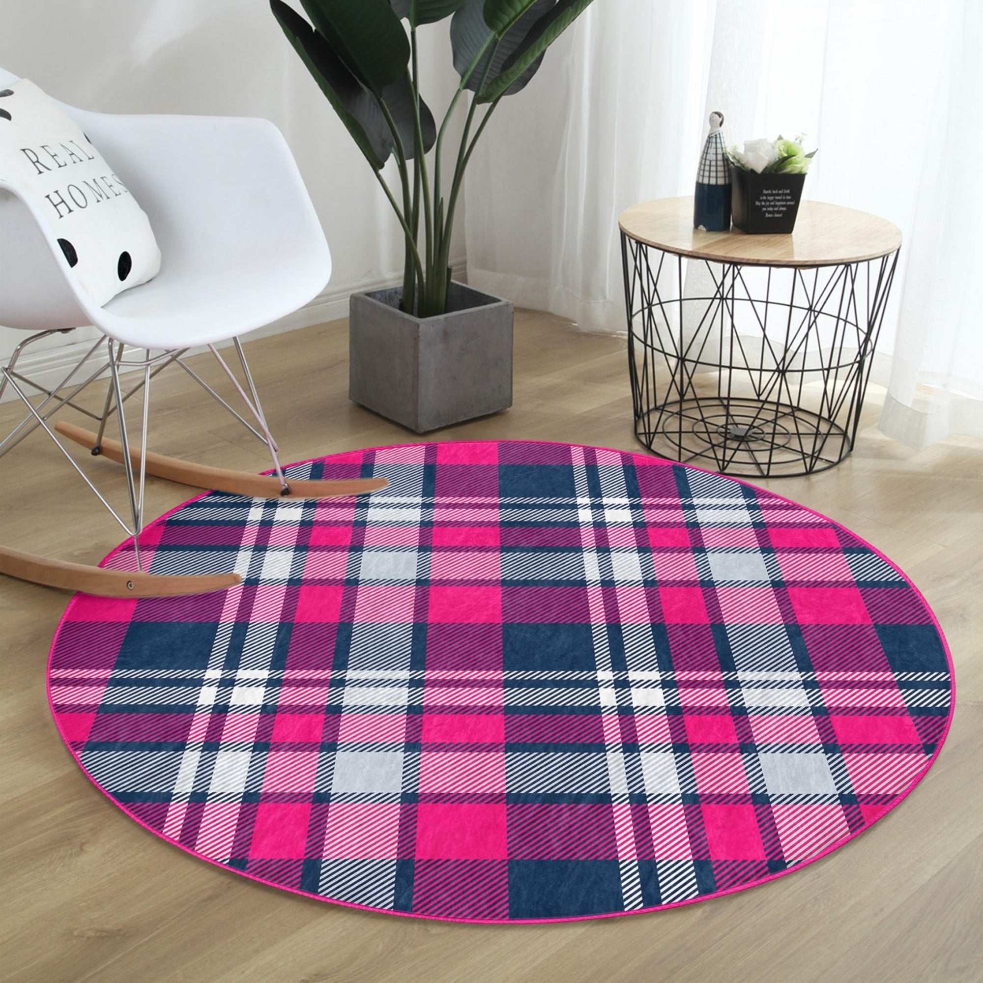 A stylish round rug featuring a pink-purple plaid pattern, showcasing its soft texture and modern design, perfect for home decor.