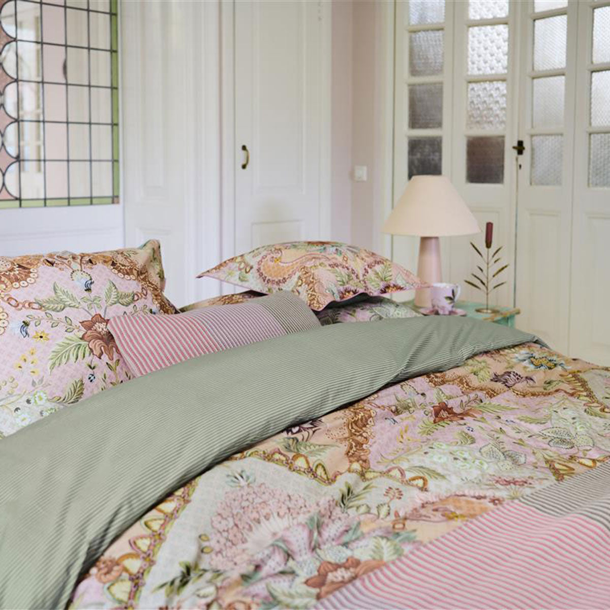 PIP Studio Saluti Grandi Pastel Cotton Quilt Cover Set featuring floral design and striped back, perfect for a stylish bedroom.