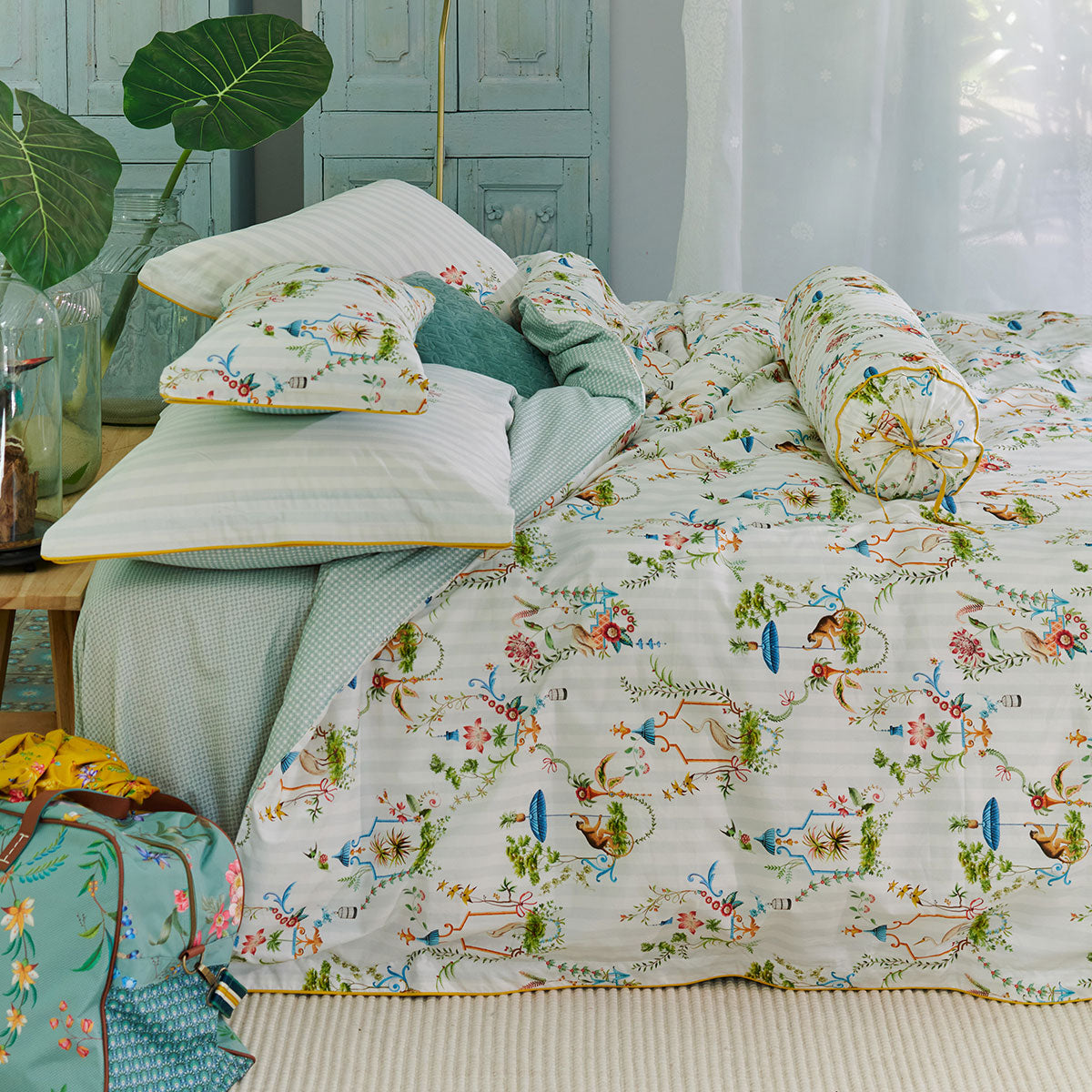 PIP Studio Singerie White Cotton Quilt Cover Set featuring vibrant bird and monkey designs in a flower-filled summer house.