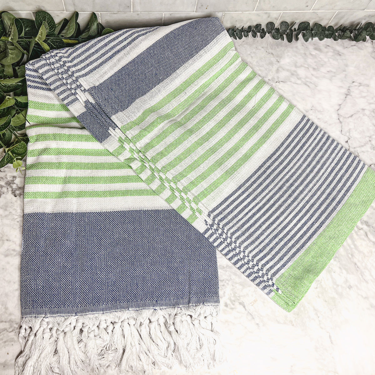 Pop of Summer Towel made from 100% Turkish cotton, featuring blue and green stripes with decorative tassels.