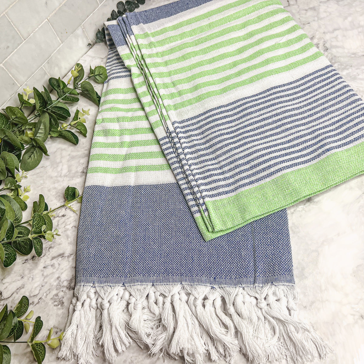 Pop of Summer Towel made from 100% Turkish cotton, featuring blue and green stripes with decorative tassels.