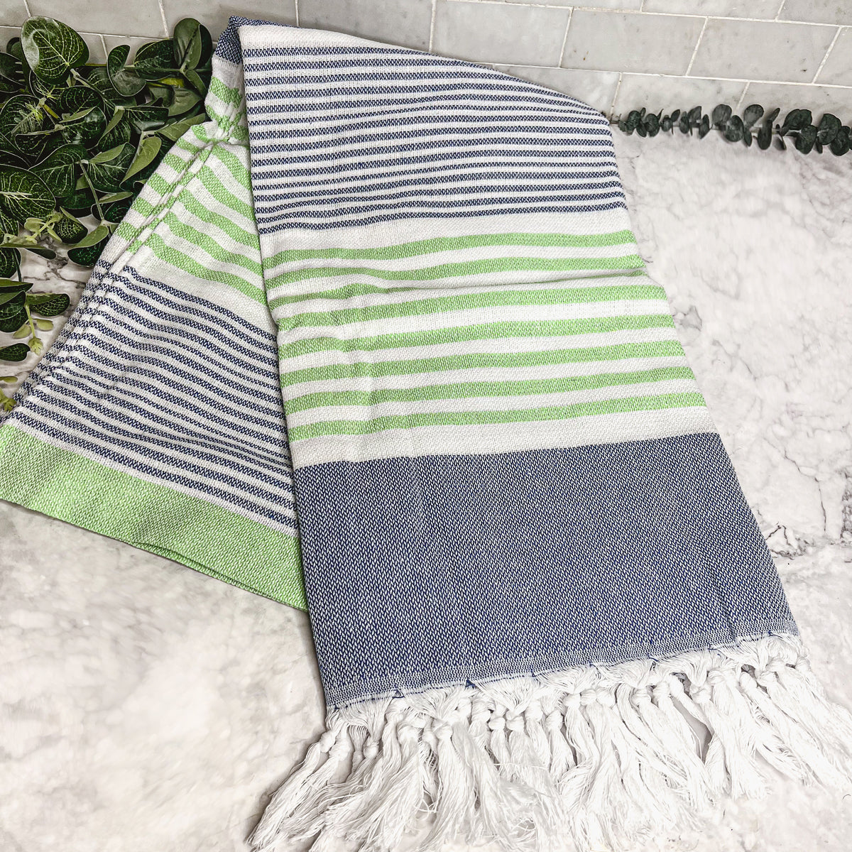 Pop of Summer Towel made from 100% Turkish cotton, featuring blue and green stripes with decorative tassels.