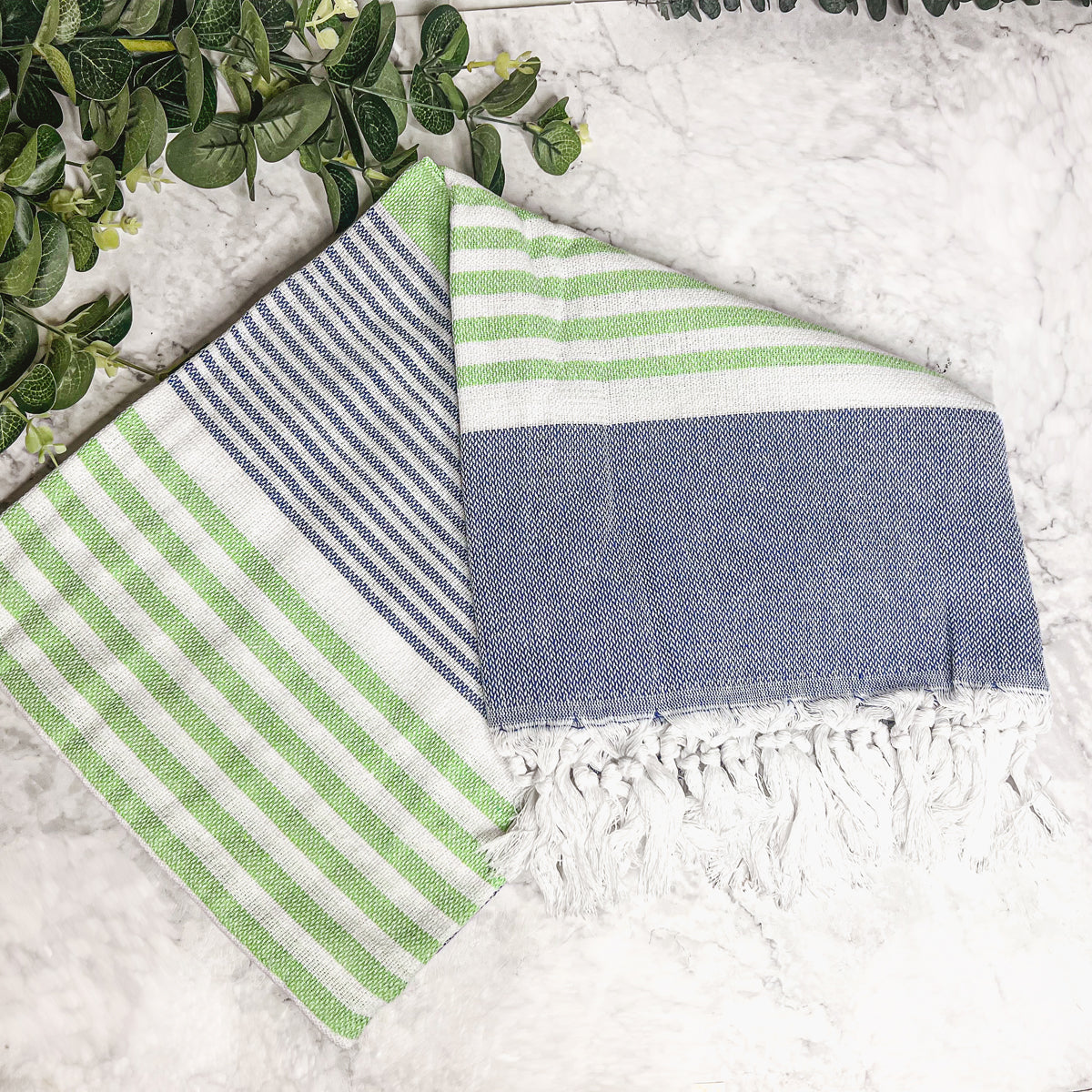 Pop of Summer Towel made from 100% Turkish cotton, featuring blue and green stripes with decorative tassels.