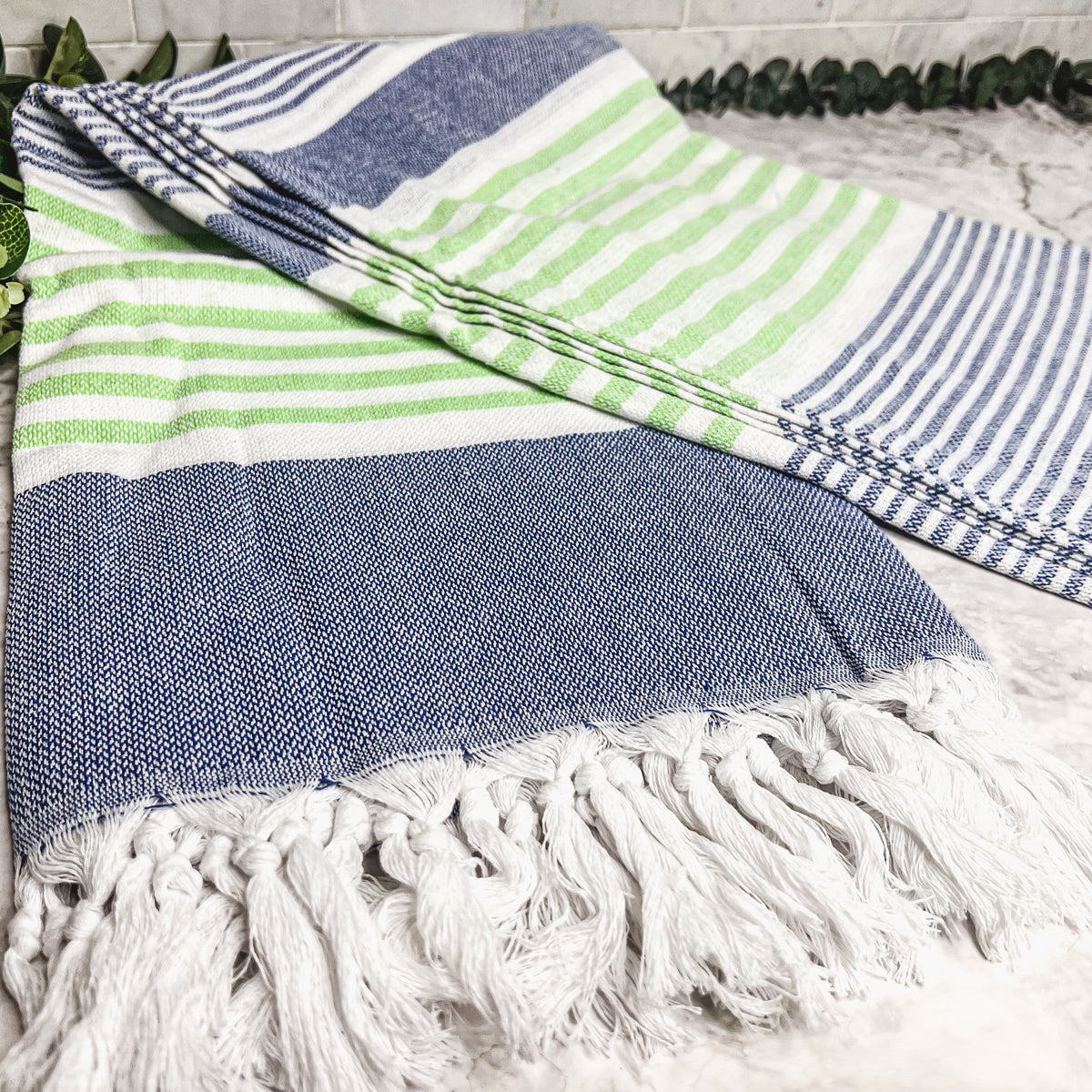 Pop of Summer Towel made from 100% Turkish cotton, featuring blue and green stripes with decorative tassels.