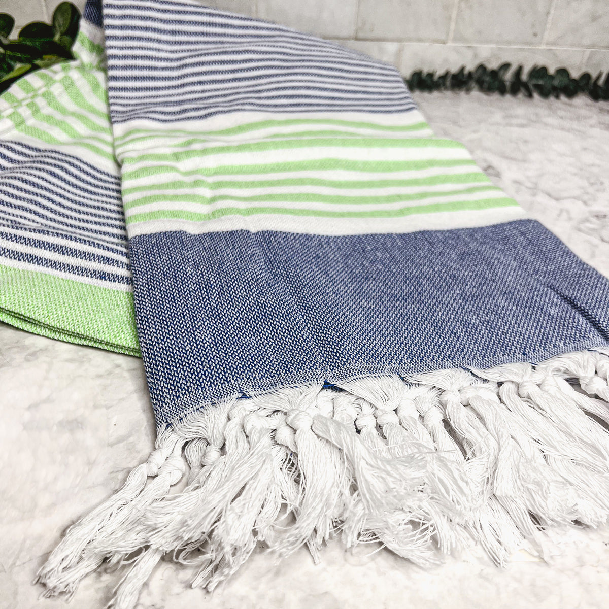 Pop of Summer Towel made from 100% Turkish cotton, featuring blue and green stripes with decorative tassels.