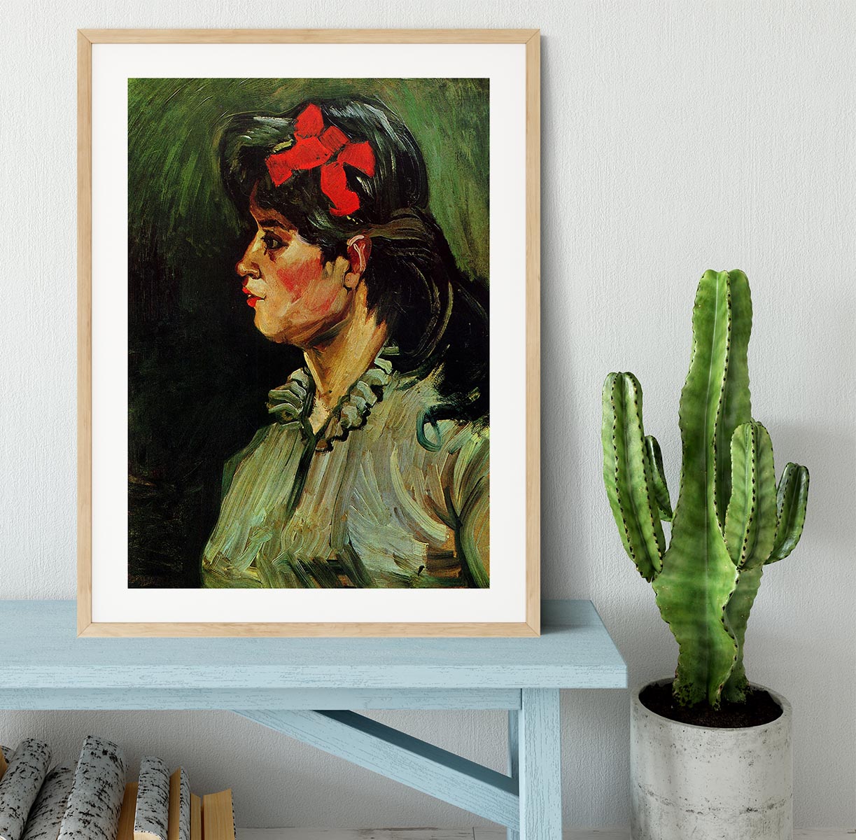Framed print of Van Gogh's Portrait of a Woman with Red Ribbon, showcasing vibrant colors and elegant framing.