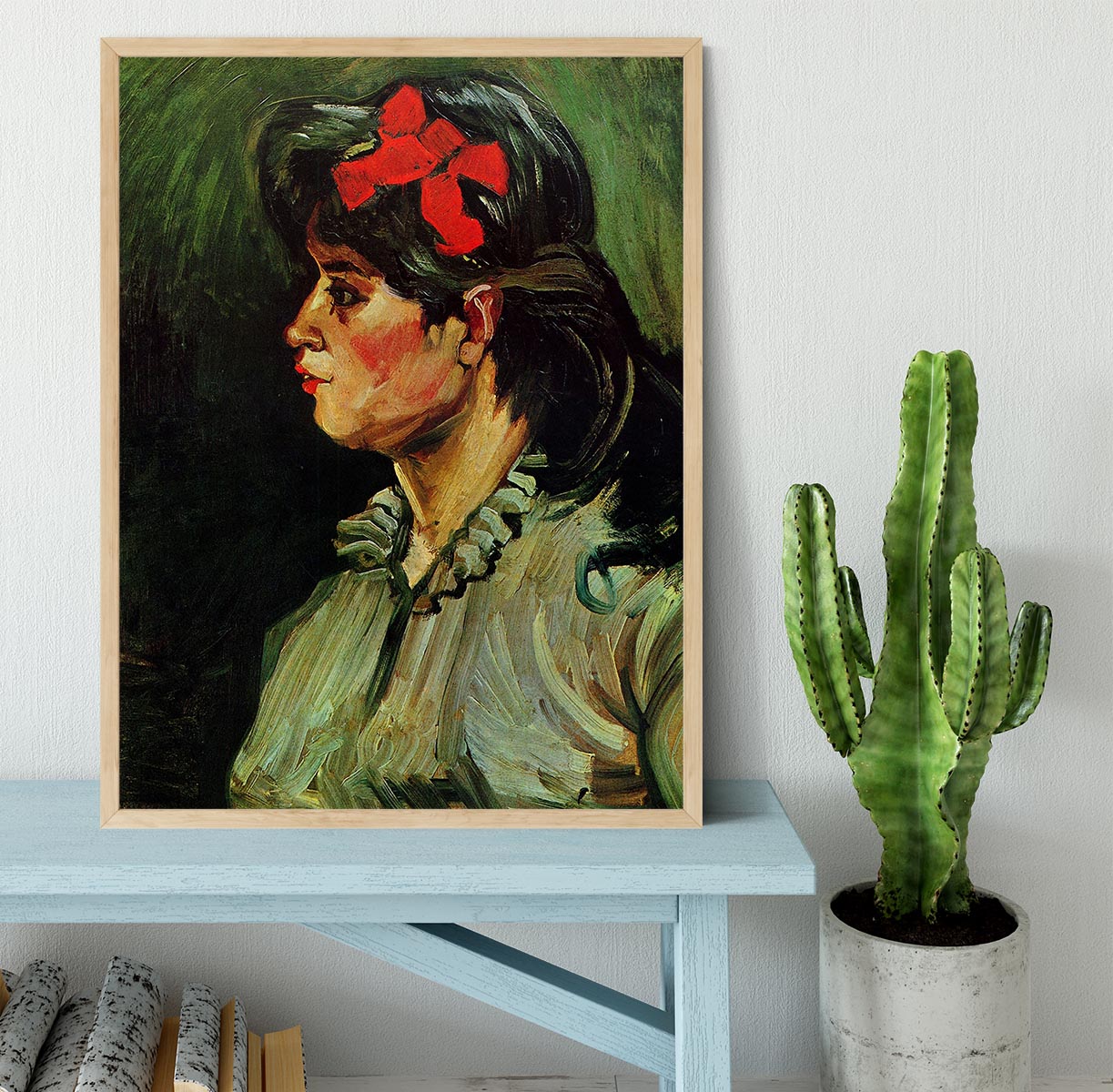 Framed print of Van Gogh's Portrait of a Woman with Red Ribbon, showcasing vibrant colors and elegant framing.