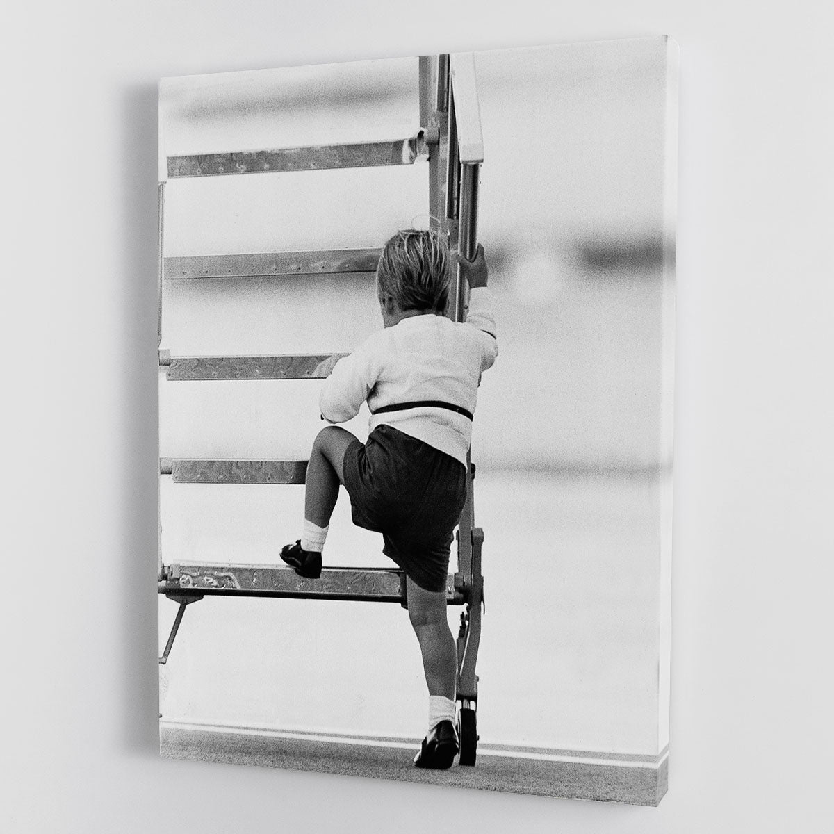 Canvas print of Prince William climbing stairs at Aberdeen Airport, showcasing royal elegance and charm.