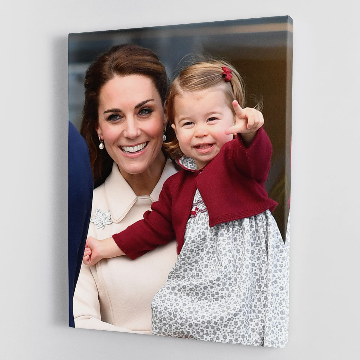Canvas print of Princess Charlotte held by her mother Kate Middleton, showcasing a heartwarming family moment.