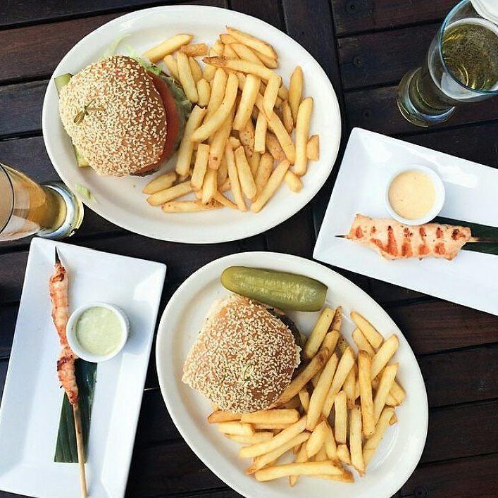 A 14-inch white oval platter with a rolled rim, made of fine porcelain, ideal for elegant dining presentations.