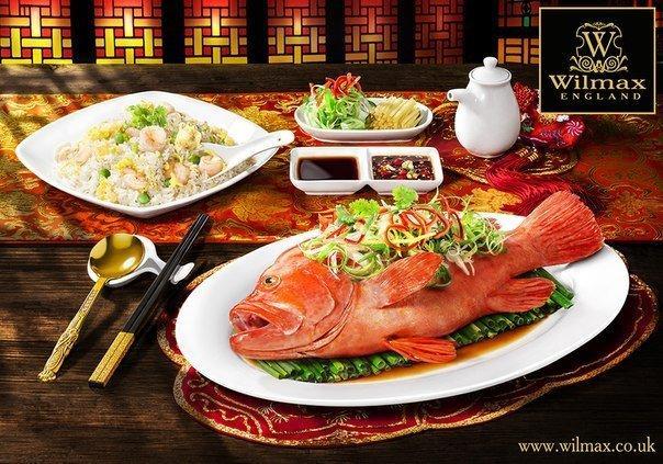 A 14-inch white oval platter with a rolled rim, made of fine porcelain, ideal for elegant dining presentations.