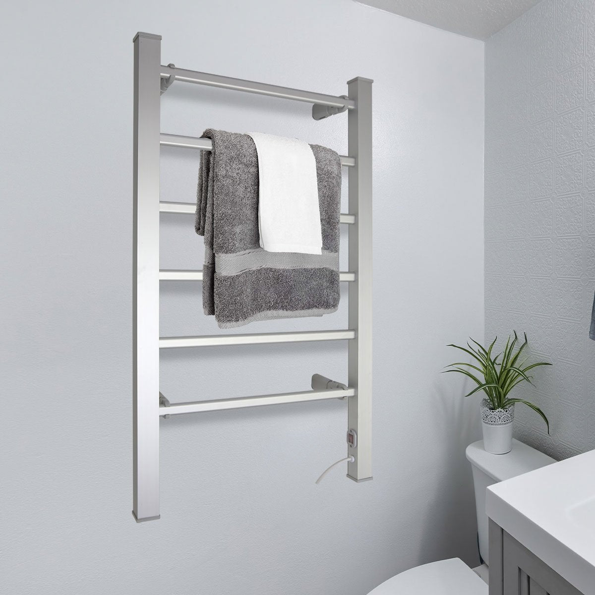Pronti Heated Towel Rack in sleek silver finish, showcasing 6 heated rails for warming towels, mounted on a bathroom wall.