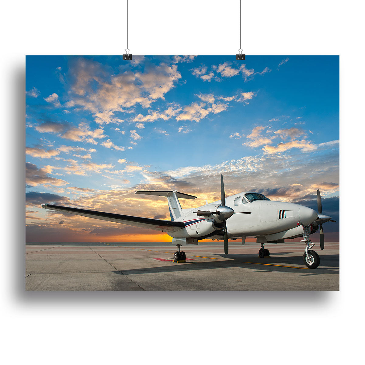 A vibrant canvas print of a propeller plane parked at an airport, showcasing detailed aircraft features and a clear blue sky.