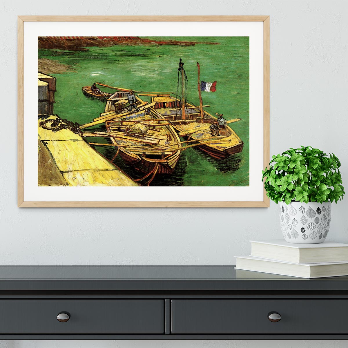 Framed print of Van Gogh's Quay with Men Unloading Sand Barges, showcasing vibrant colors and intricate details.