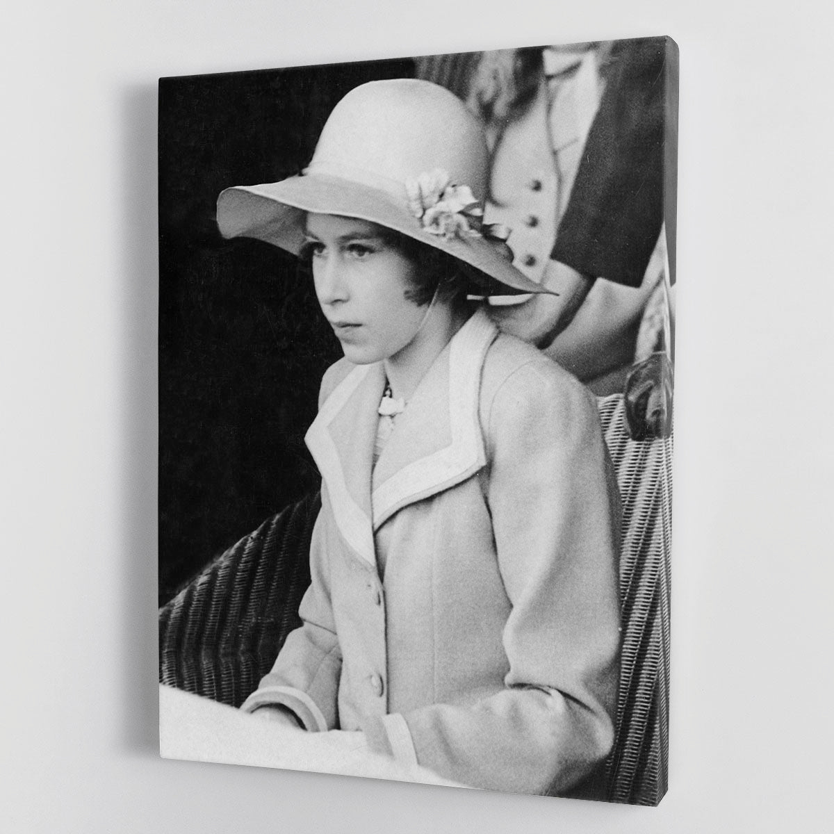 Canvas print of young Queen Elizabeth II seated in a hat, showcasing historical elegance.