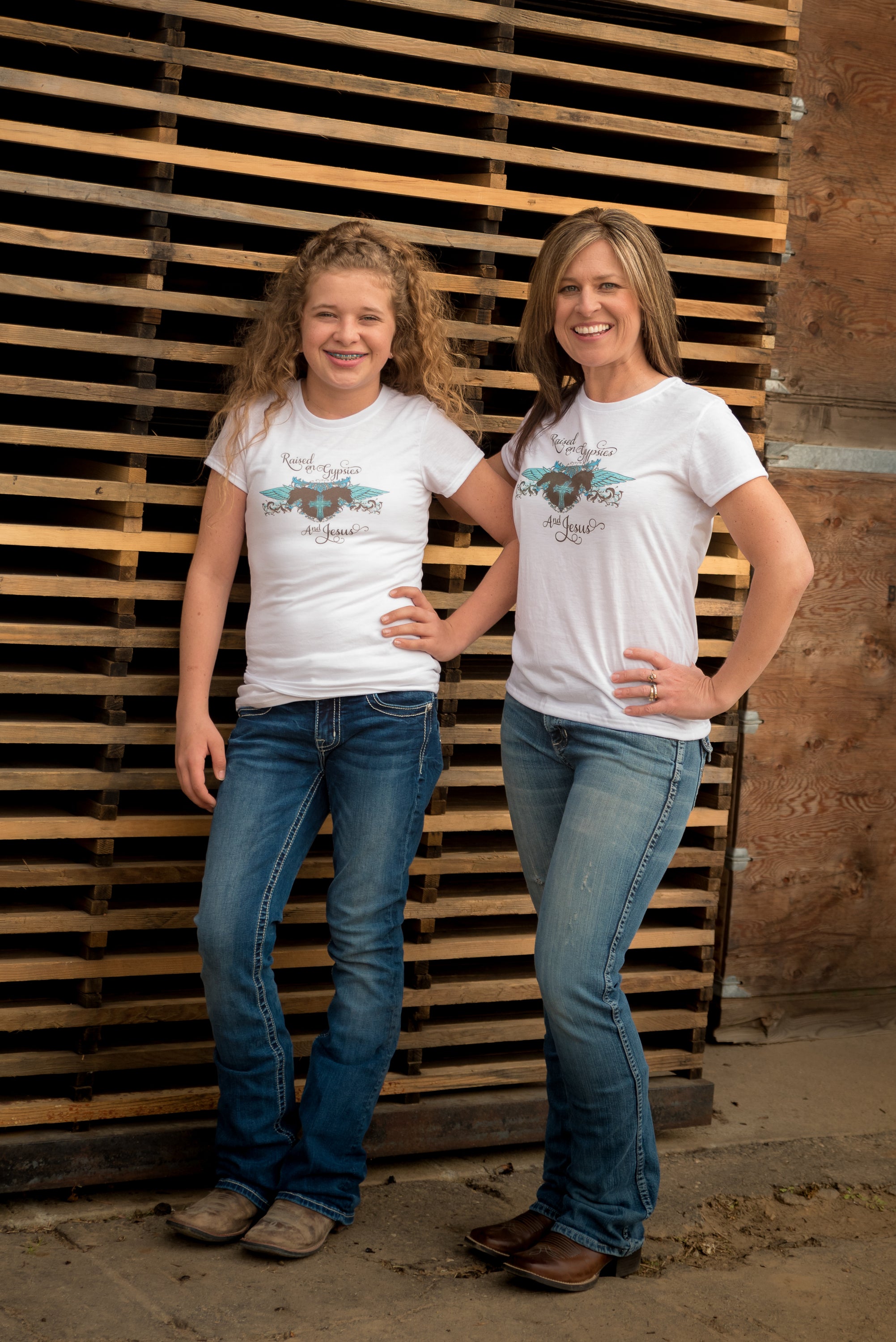 A stylish women's T-shirt featuring the phrase 'Raised on Gypsies and Jesus' in a unique design, available in various sizes.