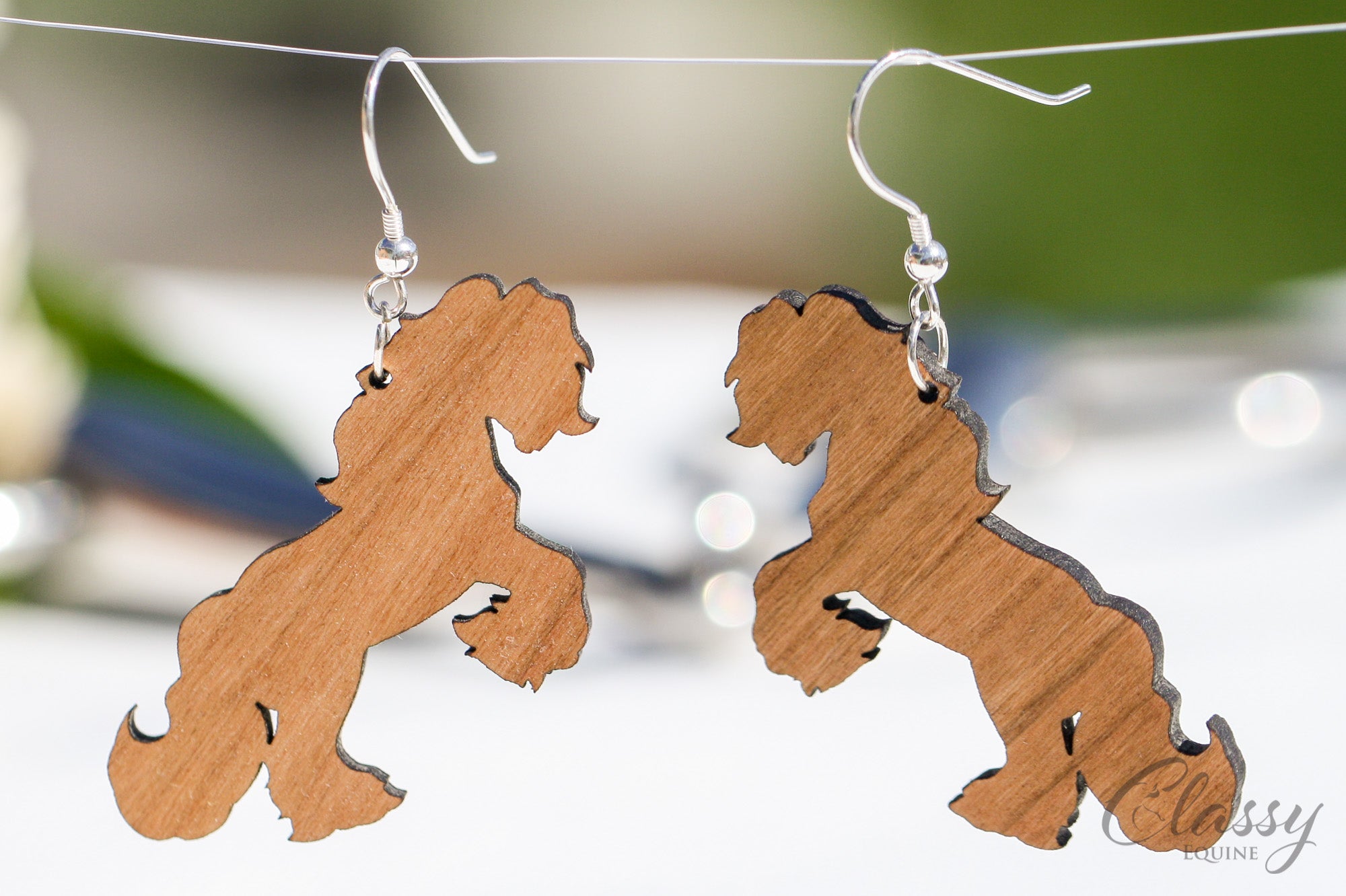 A pair of Rearing Gypsy Cob hardwood earrings, laser cut from cherry or walnut, showcasing intricate horse designs.