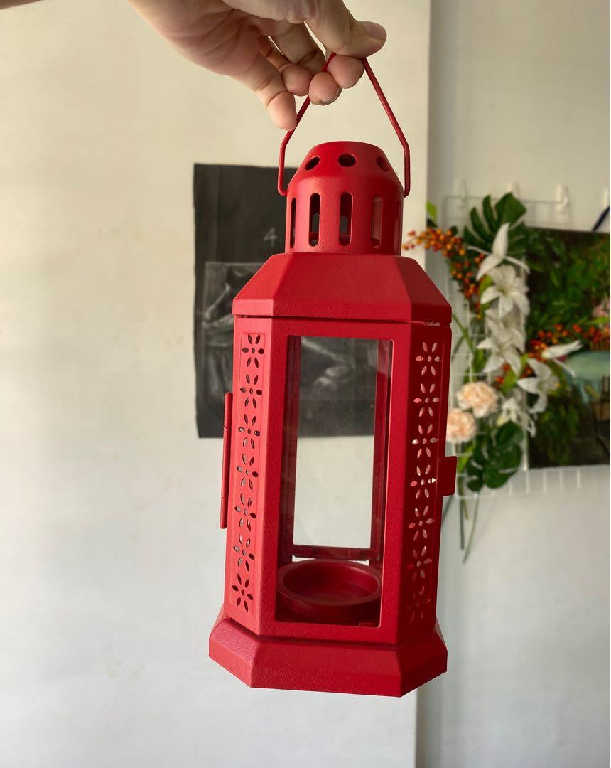 A vibrant red metal miners lantern designed for tealight candles, featuring a solid loop for hanging, perfect for weddings and home decor.