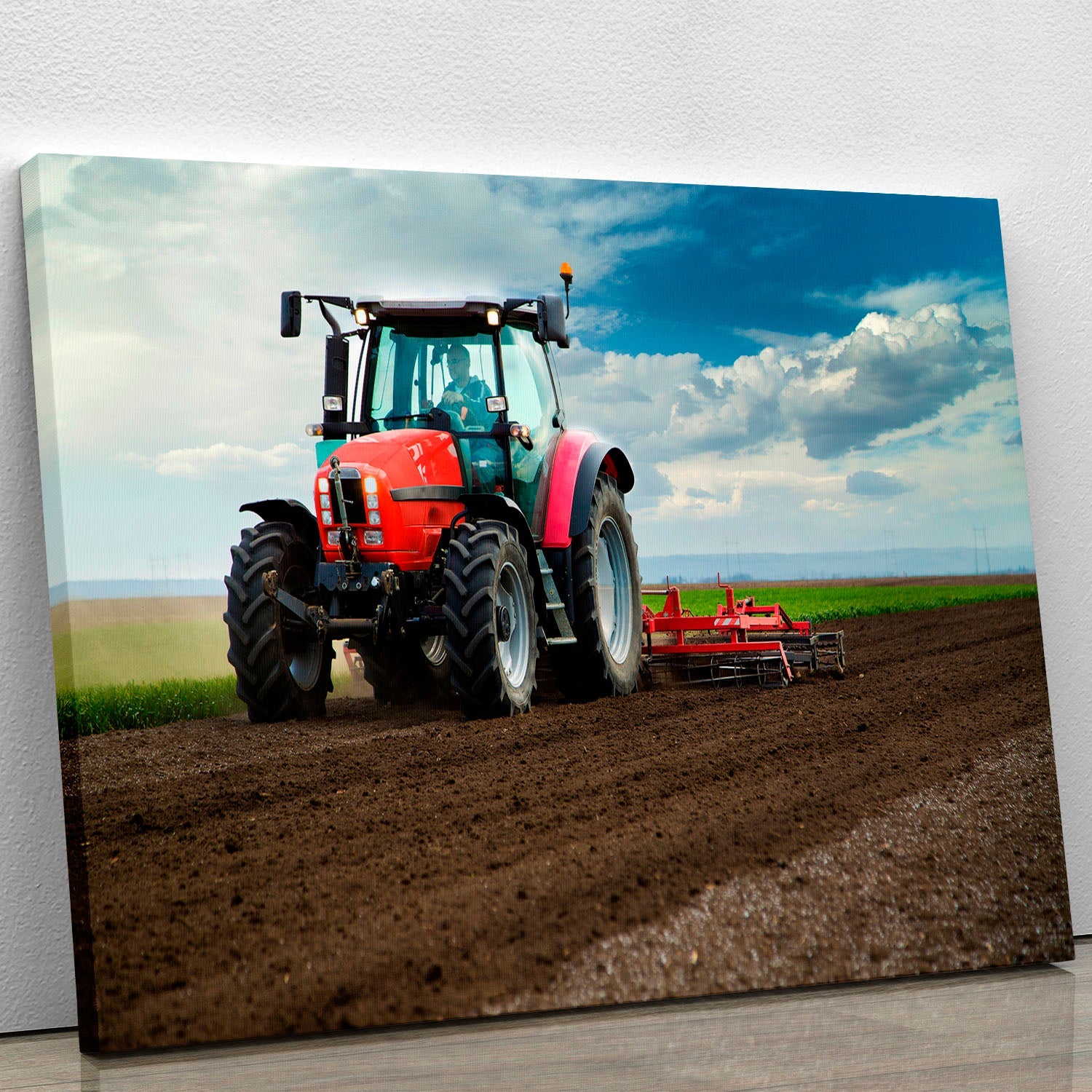 A vibrant red tractor canvas print showcasing a classic farm vehicle against a rustic backdrop, perfect for home decor.