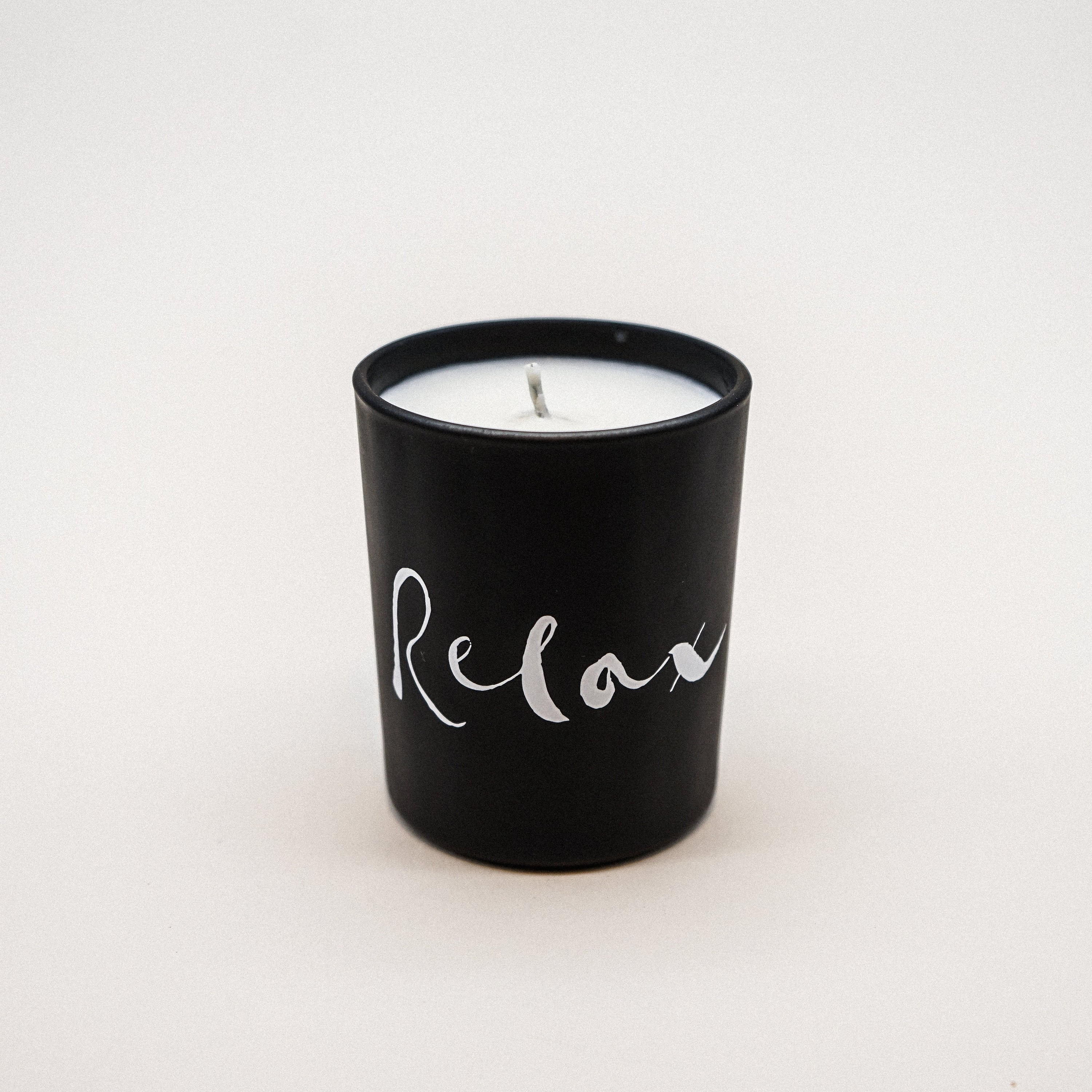 Relax Natural Wax Candle Set in elegant black glass with a relaxing brush painting design, showcasing its luxurious and calming essence.