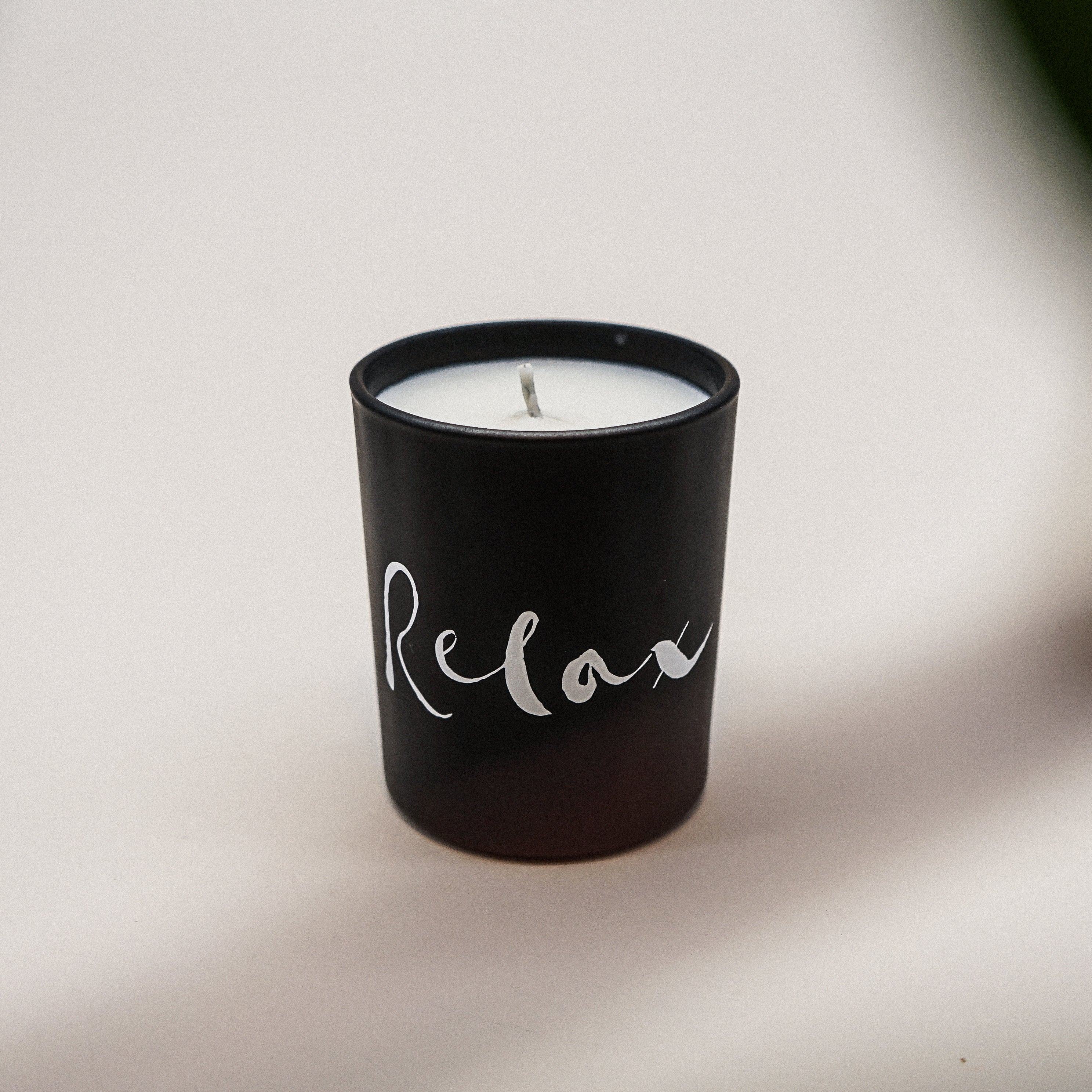 Relax Natural Wax Candle Set in elegant black glass with a relaxing brush painting design, showcasing its luxurious and calming essence.