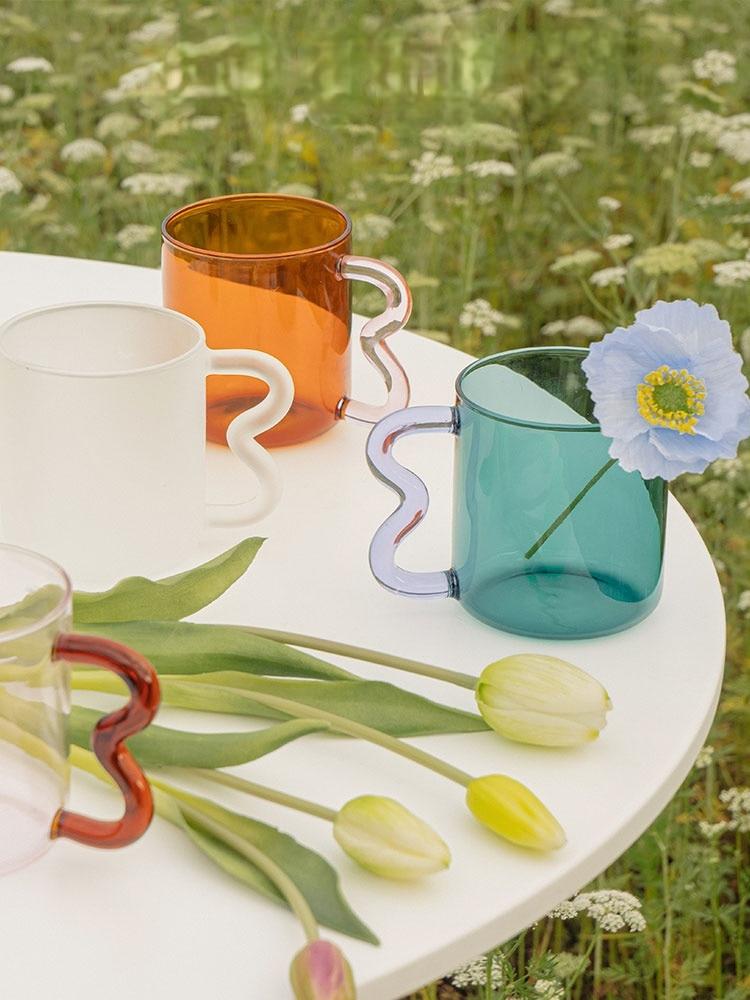 A colorful Retro Wavy Mug with a stained-glass finish and ergonomic handle, showcasing its unique design and vibrant colors.