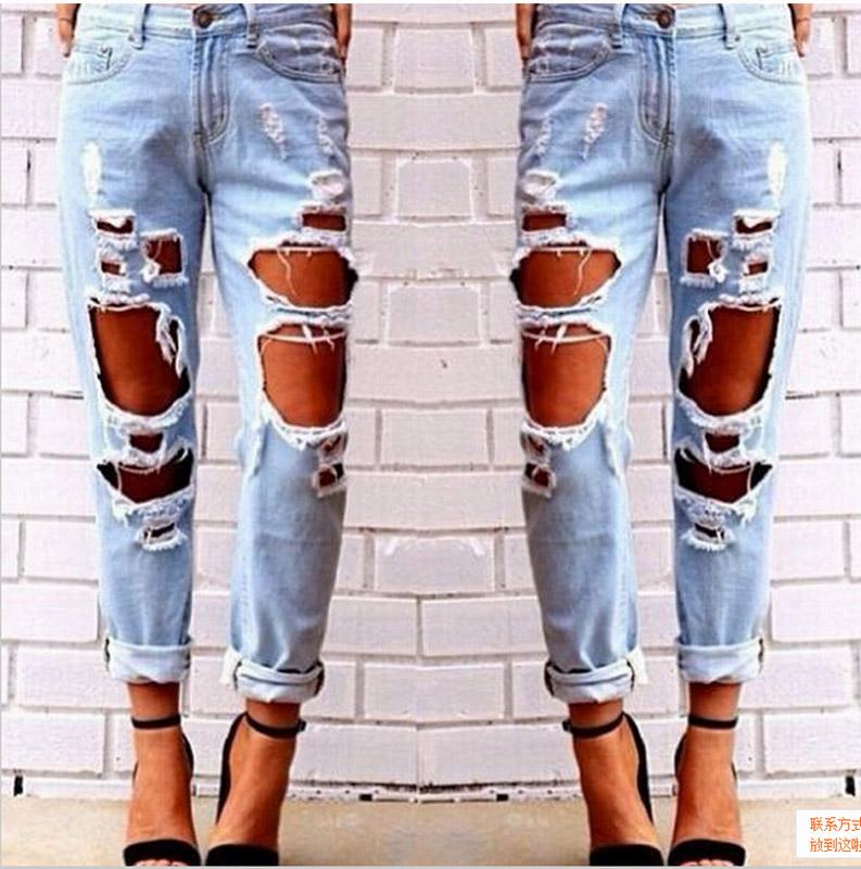 Ripped jeans denim joggers for women featuring knee holes and a slim fit in blue color.