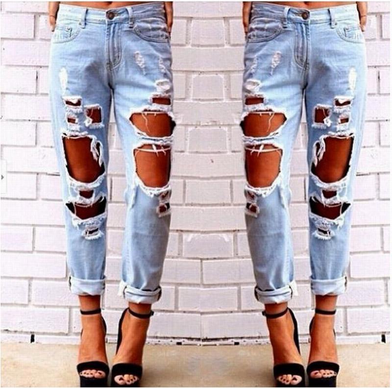 Ripped jeans denim joggers for women featuring knee holes and a slim fit in blue color.
