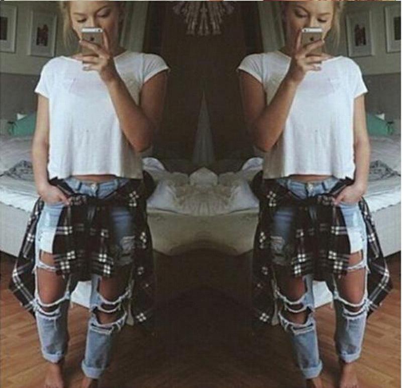 Ripped jeans denim joggers for women featuring knee holes and a slim fit in blue color.