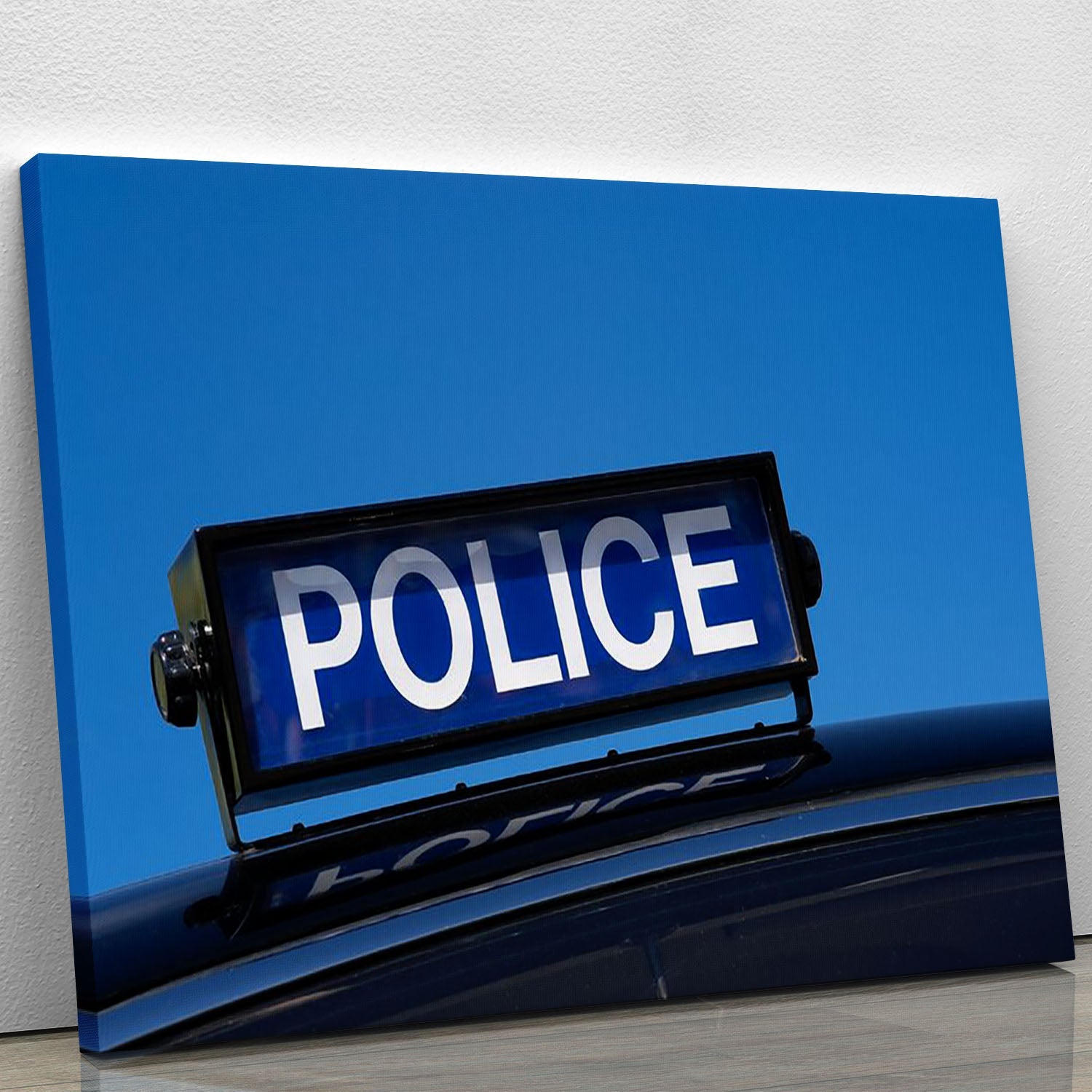 A vintage British police car canvas print featuring a rooftop sign, showcasing classic design and vibrant colors.
