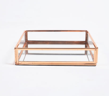 Rose-gold stainless steel and glass vanity tray, showcasing elegant design and craftsmanship.