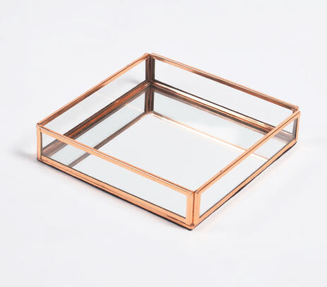 Rose-gold stainless steel and glass vanity tray, showcasing elegant design and craftsmanship.