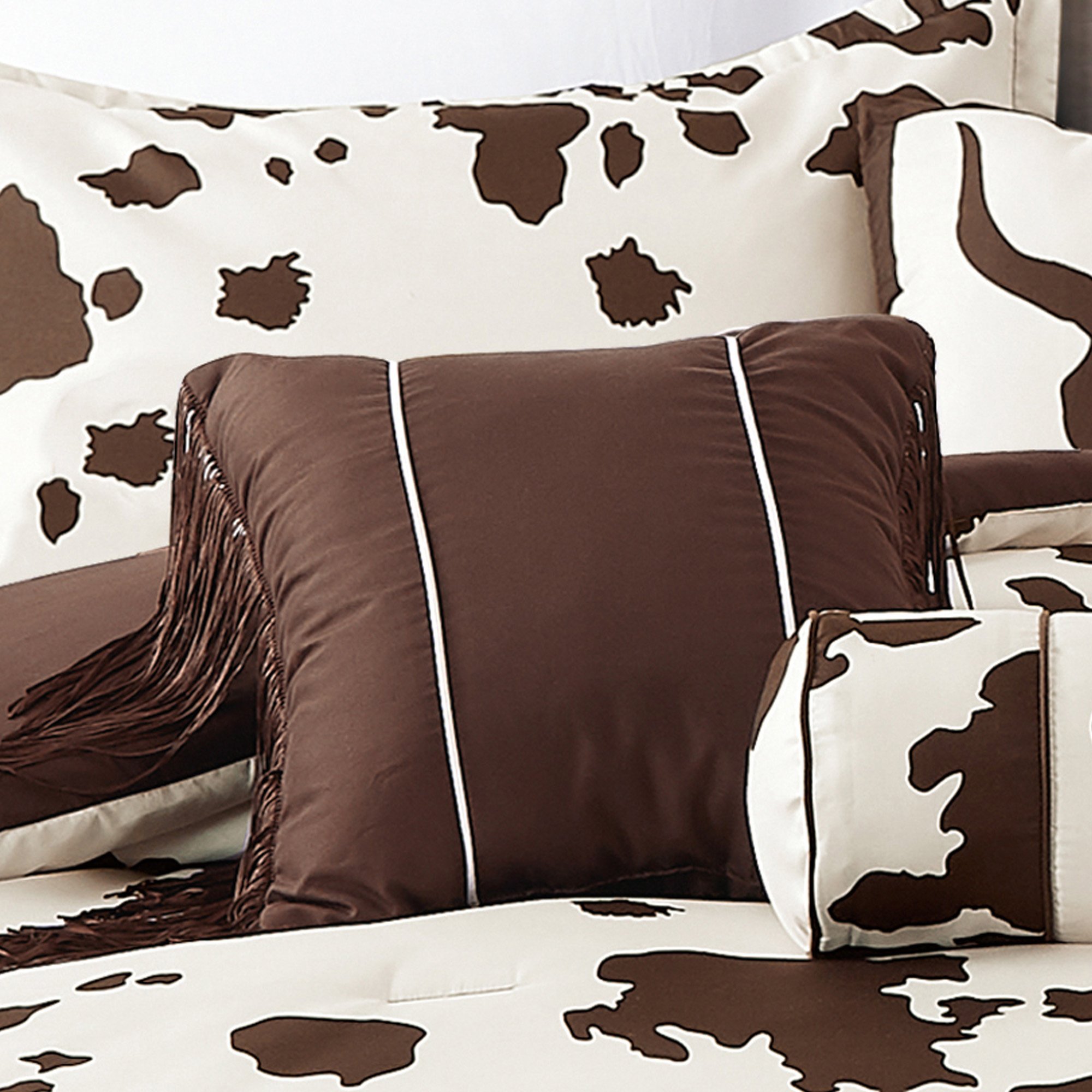 Rustic Cowhide Brown Cow Skull Comforter Set displayed on a bed, featuring a luxurious design with matching pillows and bed skirt.
