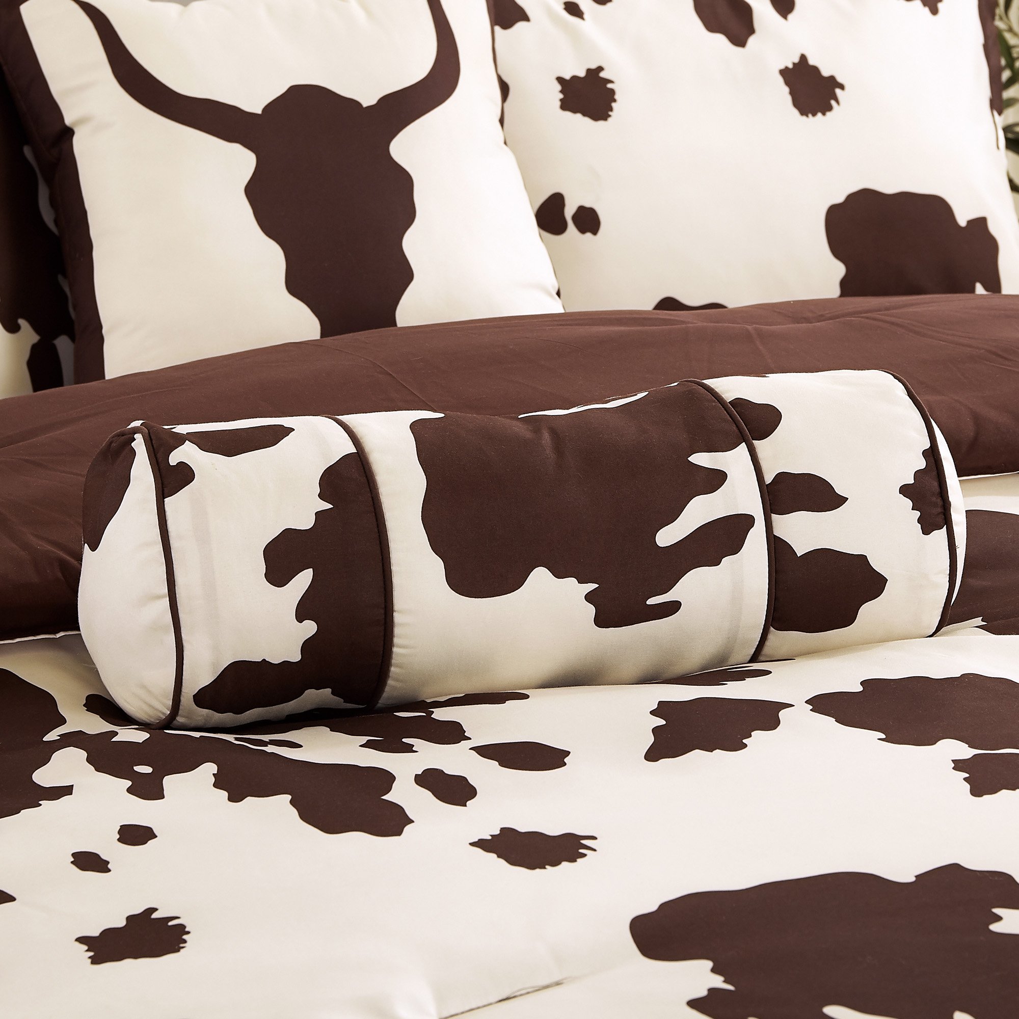 Rustic Cowhide Brown Cow Skull Comforter Set displayed on a bed, featuring a luxurious design with matching pillows and bed skirt.