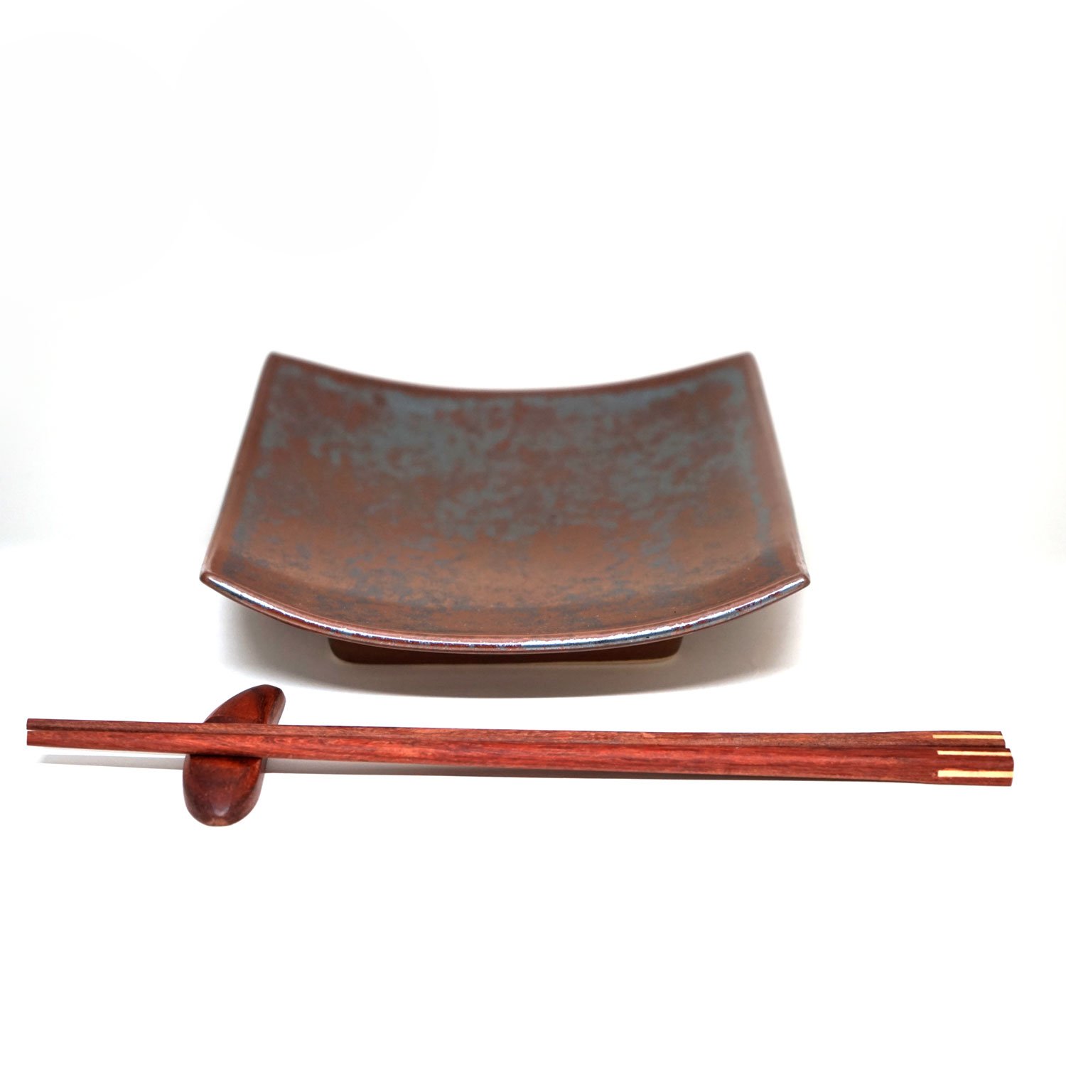 A beautifully crafted Rustic Effect Plate Set featuring unique handmade square plates, wooden chopsticks, and a chopstick rest, showcasing a tranquil design.