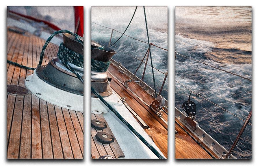 A stunning 3-panel canvas print depicting a sail boat navigating through a stormy sea, showcasing dramatic skies and waves.