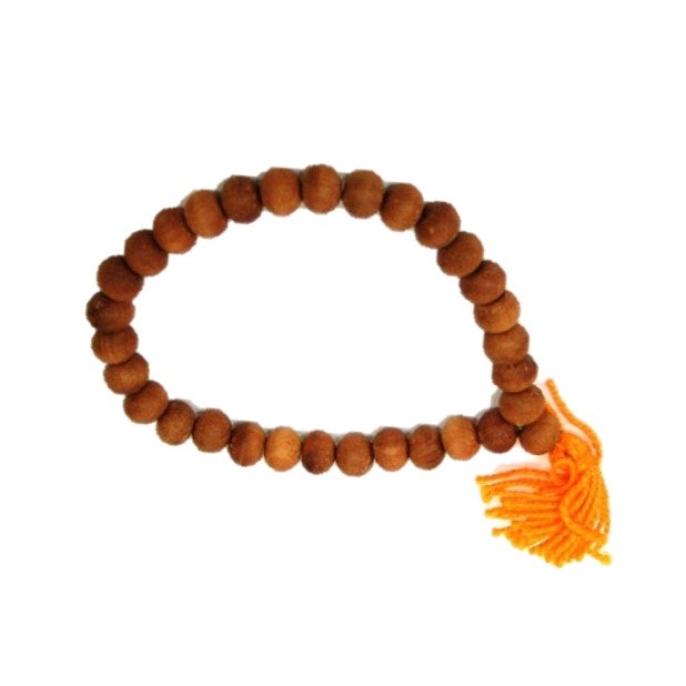 A stylish sandalwood bracelet featuring elegant tassels, designed to fit all wrist sizes.