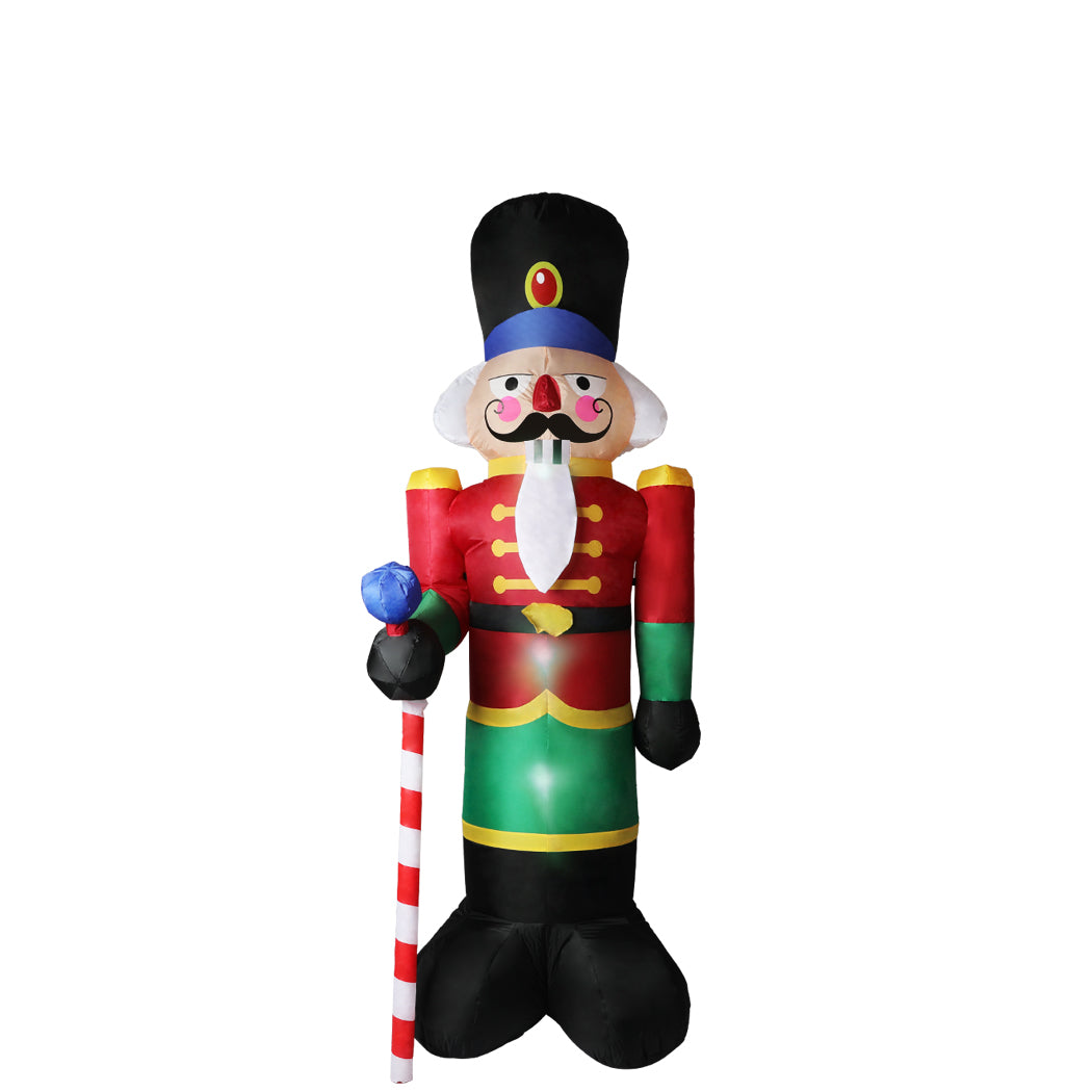 A large inflatable Christmas nutcracker standing 2.4 meters tall, adorned with colorful LED lights, set against a festive outdoor backdrop.