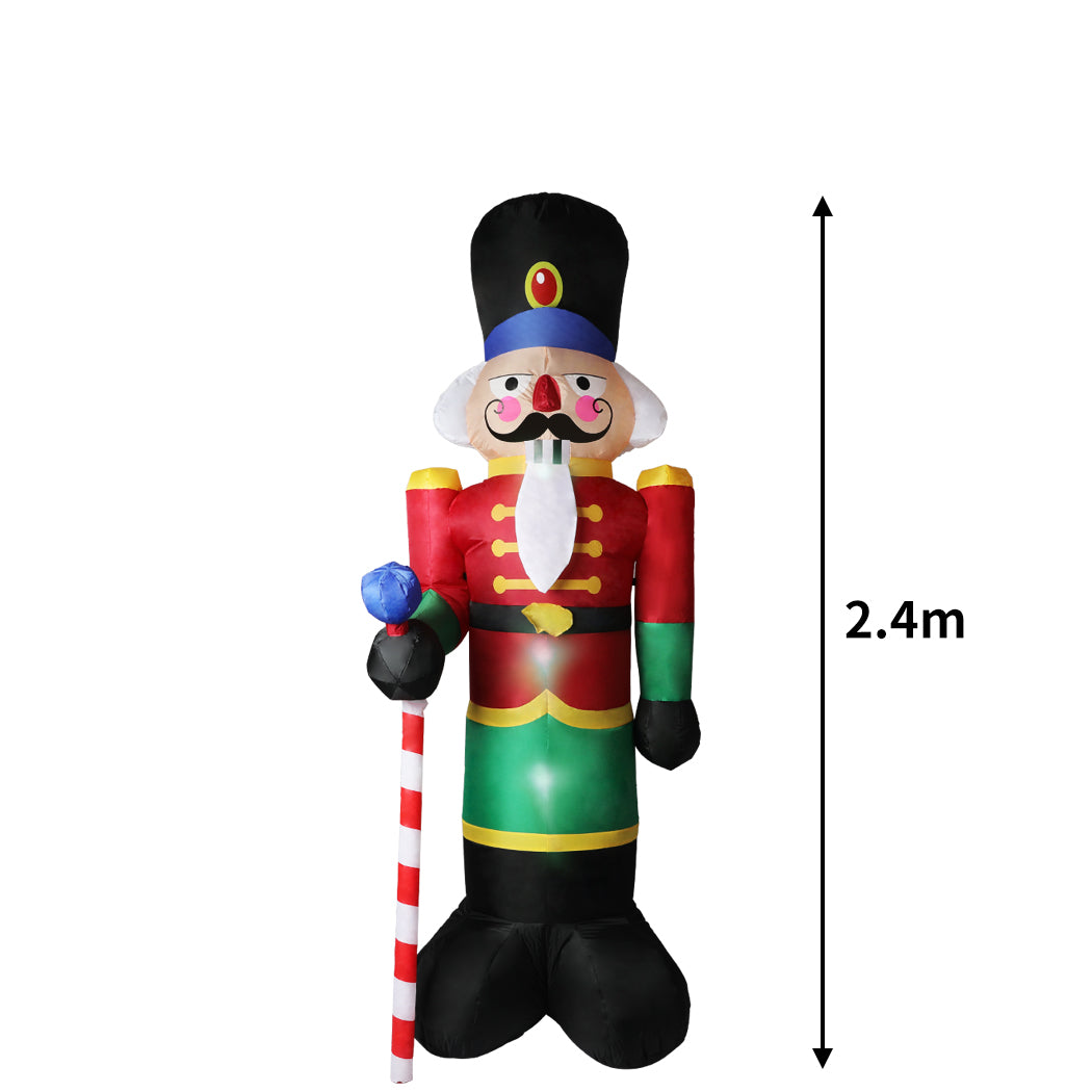 A large inflatable Christmas nutcracker standing 2.4 meters tall, adorned with colorful LED lights, set against a festive outdoor backdrop.