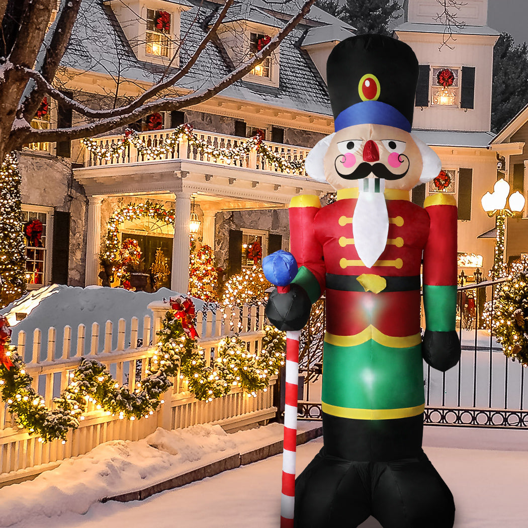 A large inflatable Christmas nutcracker standing 2.4 meters tall, adorned with colorful LED lights, set against a festive outdoor backdrop.