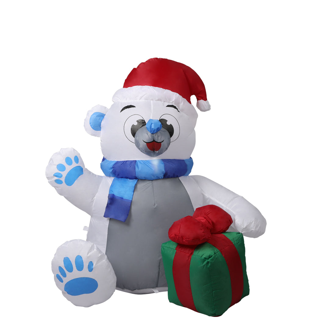 A 1.2M inflatable Christmas polar bear with LED lights, standing in a festive yard, showcasing its cheerful design and bright illumination.