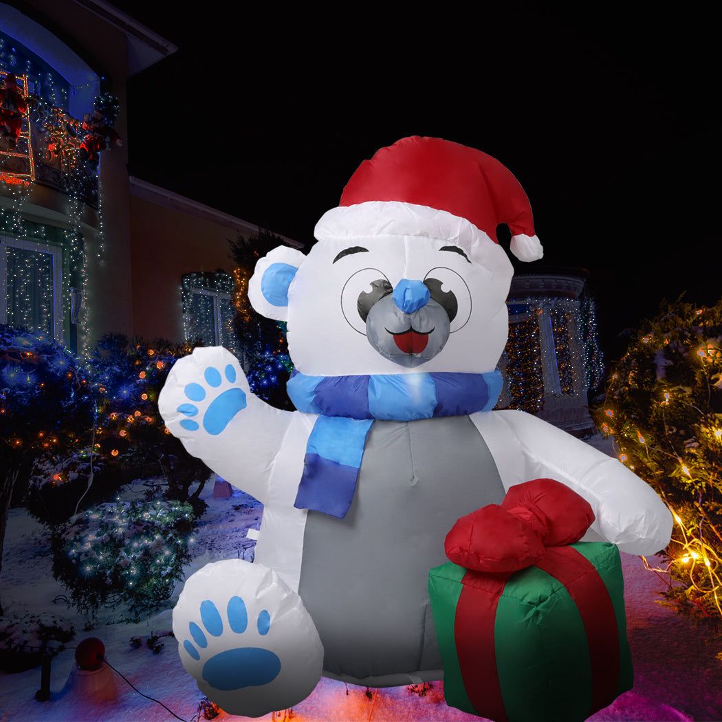 A 1.2M inflatable Christmas polar bear with LED lights, standing in a festive yard, showcasing its cheerful design and bright illumination.