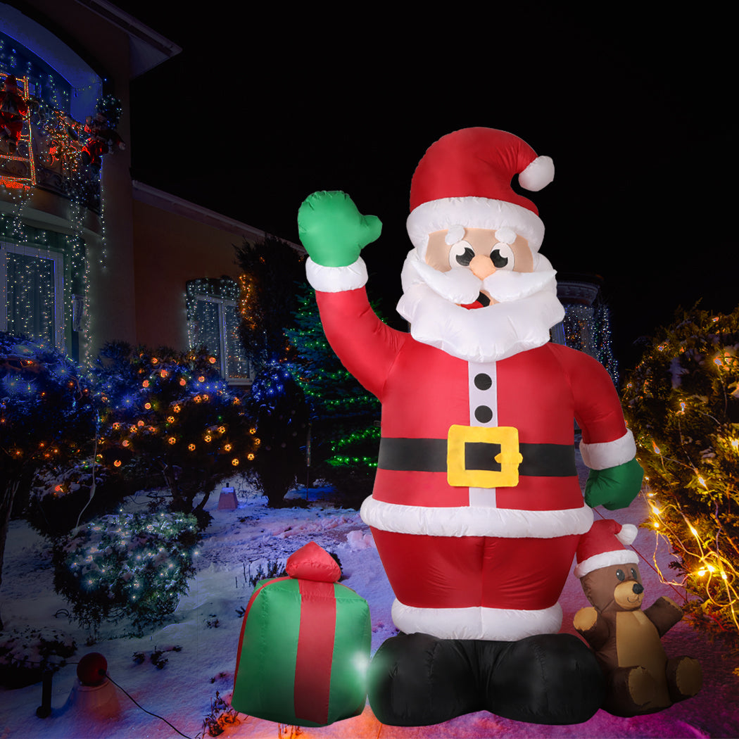 A large inflatable Santa Claus decoration with LED lights, standing 2.4 meters tall, set up outdoors for Christmas festivities.