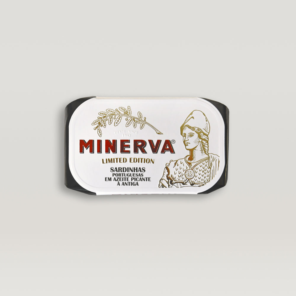 A can of limited edition sardines in spiced olive oil, featuring pickles and spices, beautifully presented for gourmet enjoyment.